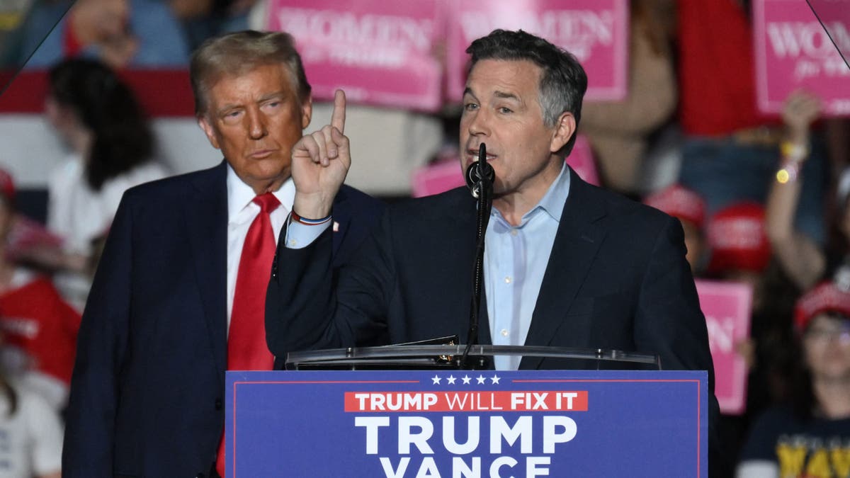 McCormick speaking at rally with Trump behind him