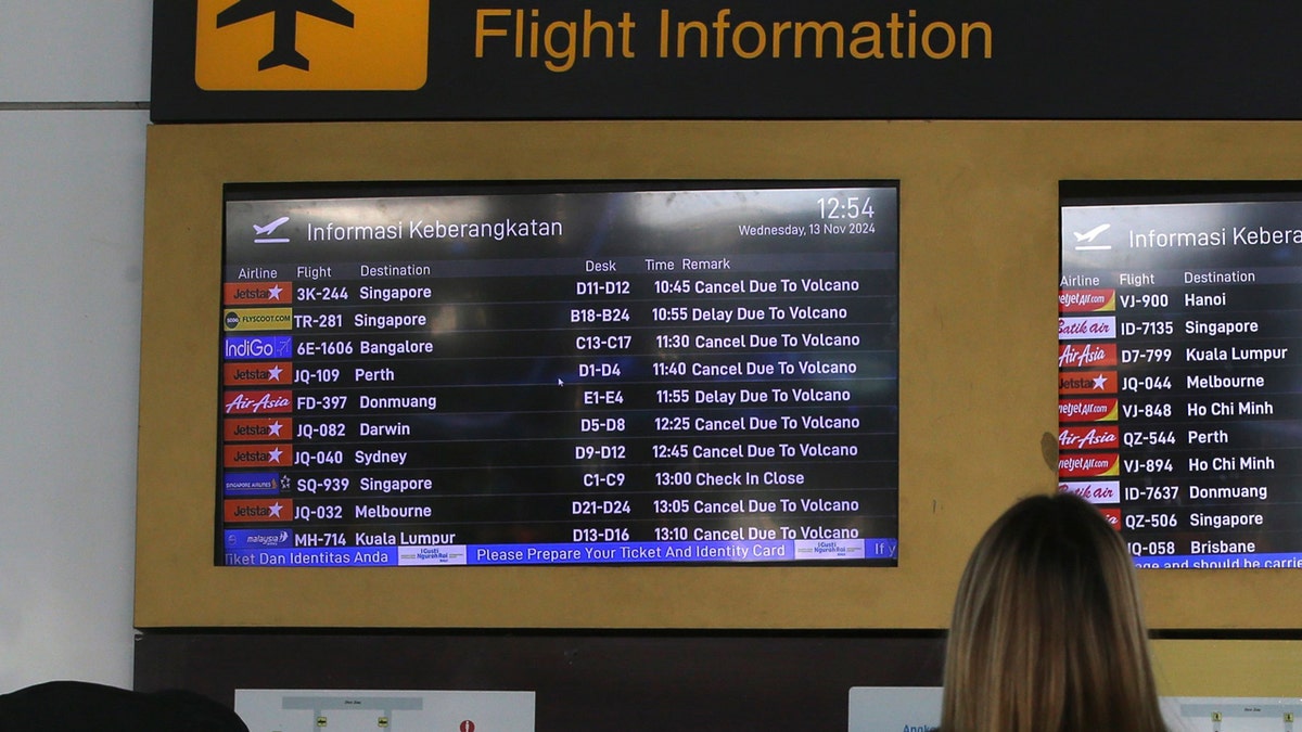 A board labeled "Flight Information" shows the statuses of various flights.