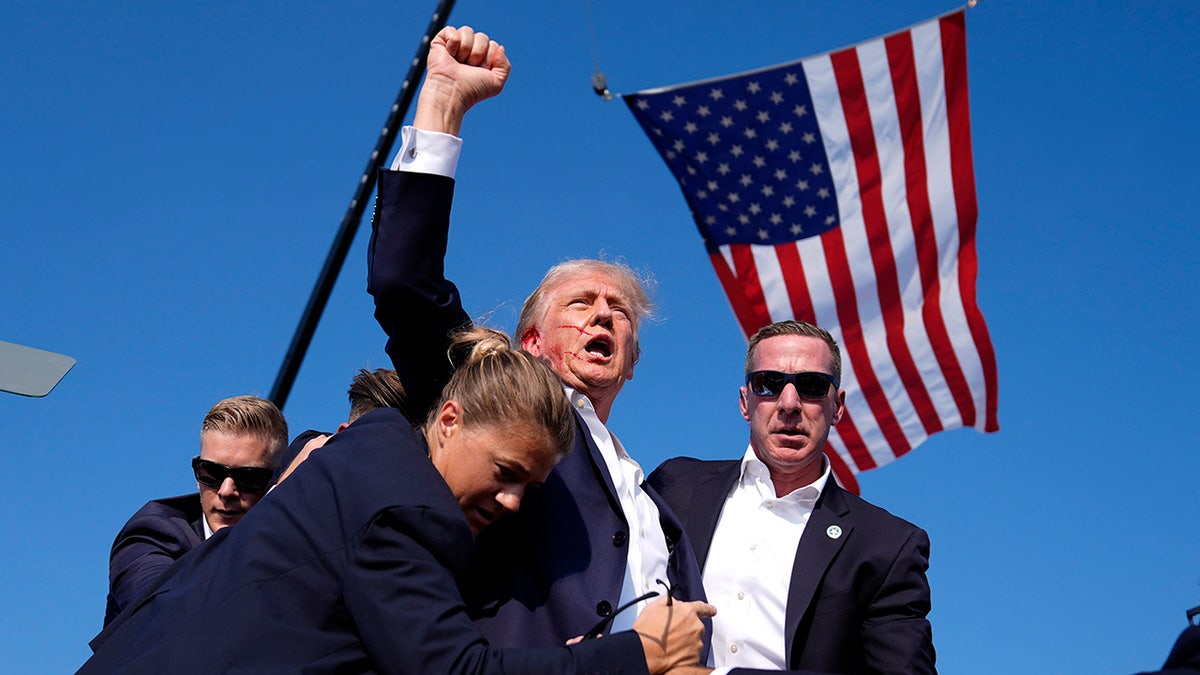 Donald Trump is surrounded by U.S. Secret Service agents at a campaign rally in Butler