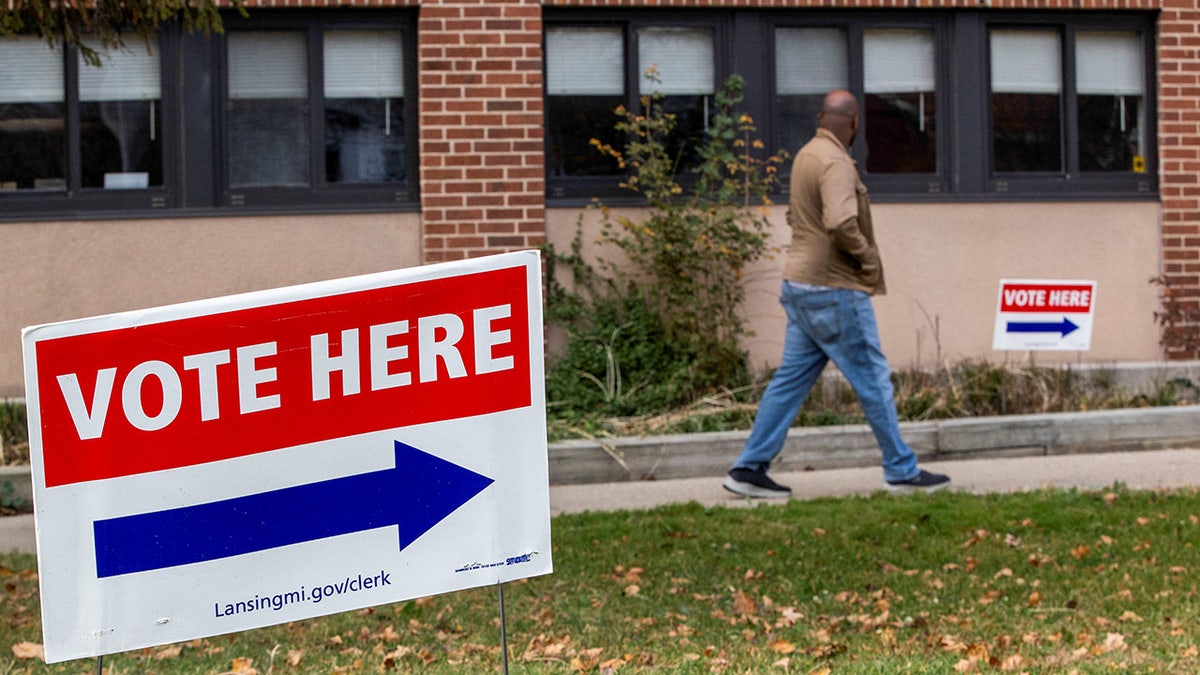 A person arrives to cast their early ballot on the last day of early voting in Michigan at a polling station