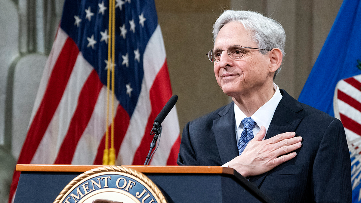 Merrick Garland at DOJ lectern with US flag behind him