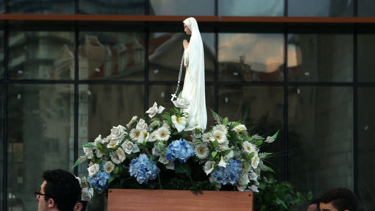 Lebanese Christian Syriac Catholic scouts carry a statue of the Virgin Mary during a procession marking the month of the Virgin Mary in a Christian dominated neighbourhood of Beirut on May 27, 2016. The Syriac Catholic Church belongs to the See of Antioch and extends it roots back to the origins of Christianity in the Levant. 