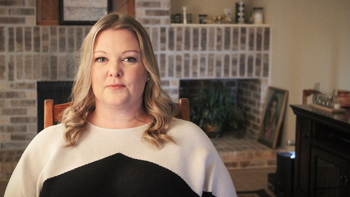 A close-up of Shanna wearing a white and black sweater.