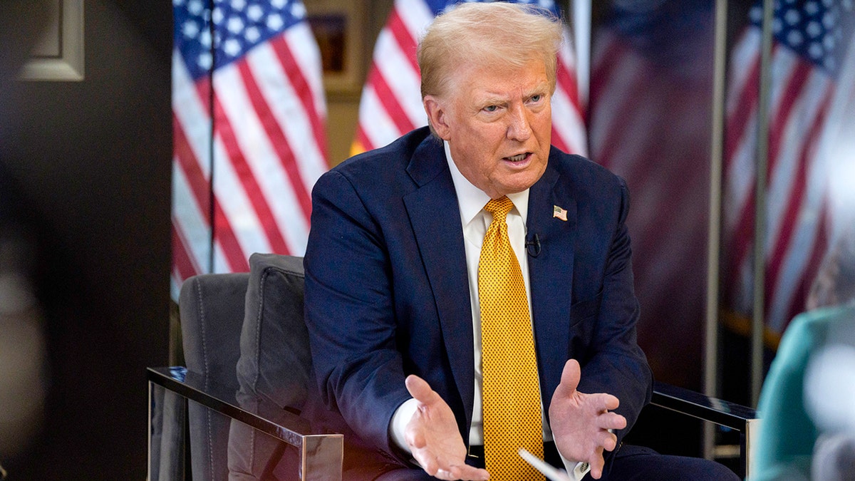 Donald Trump in bright yellow tie, seated