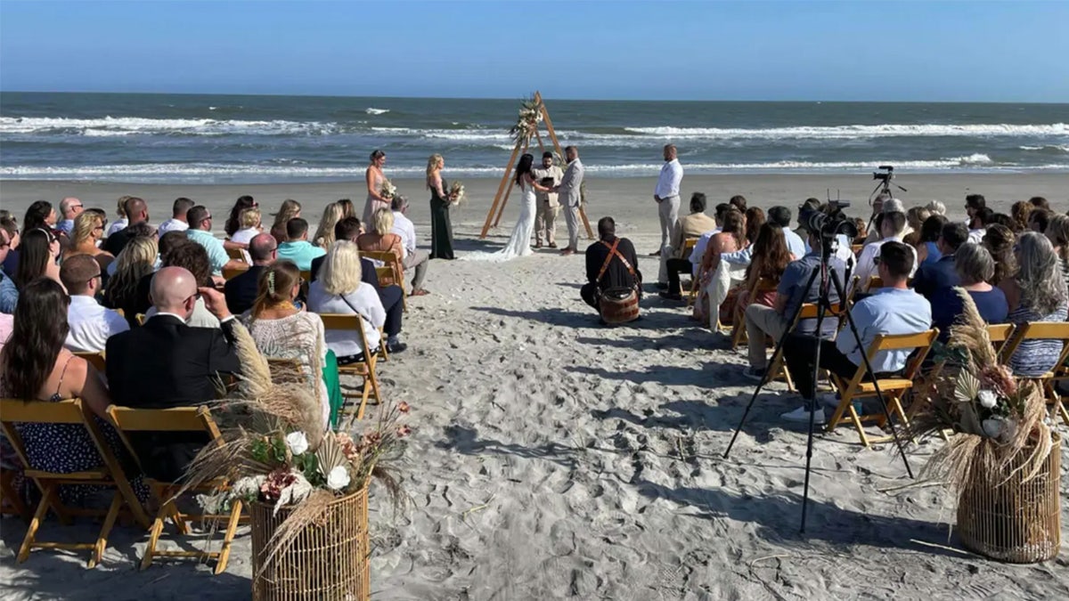 Aric Hutchinson and Samantha Miller tie the knot on the beach.