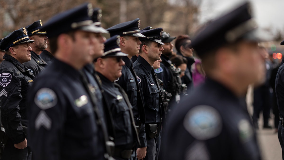 Boulder Police Officers stand at attention during a memorial for slain Boulder Police Officer Eric Talley on March 22, 2022 in Boulder, Colorado.