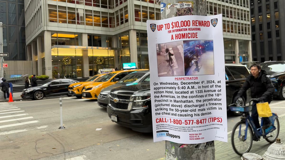 Signage posted around Midtown Manhattan asks for the public’s help in locating the suspect wanted for the shooting death of UnitedHealthcare CEO Brian Thompson