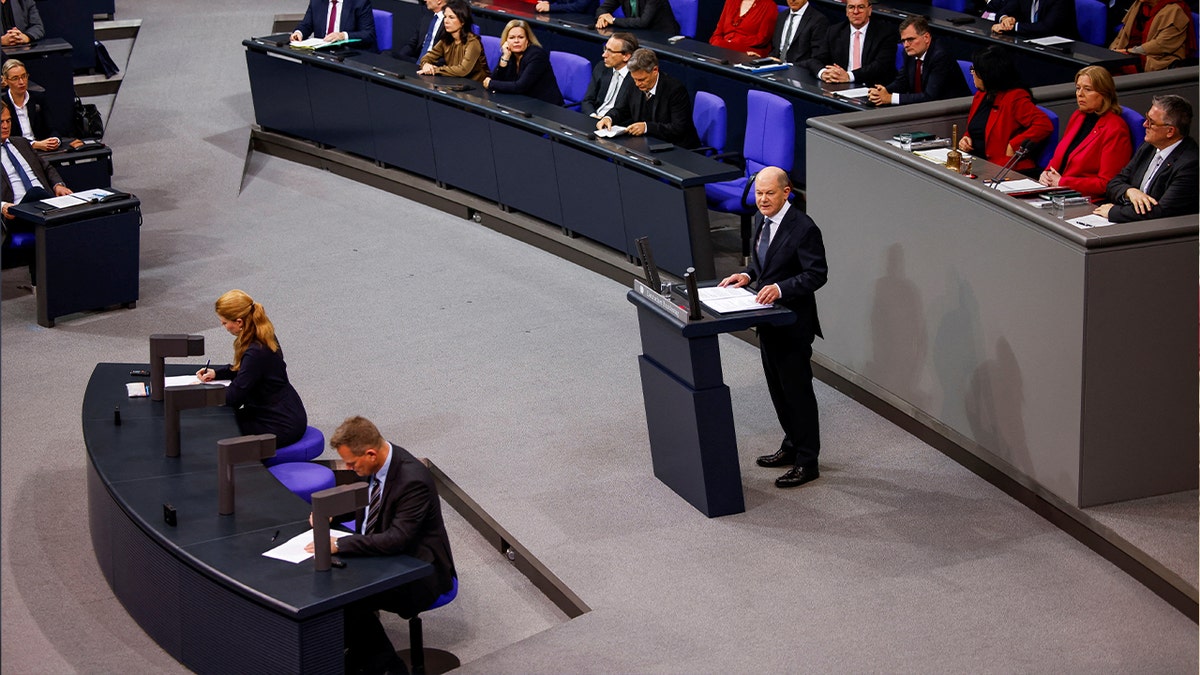 German Chancellor Olaf Scholz speaks at podium