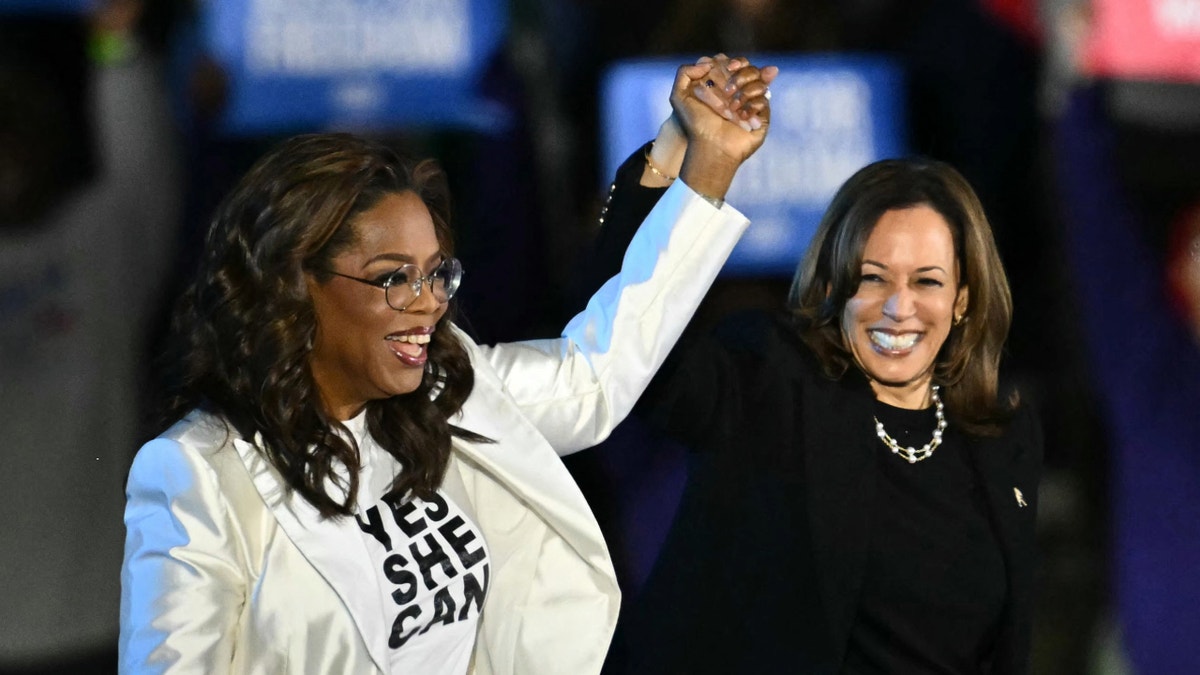 Oprah Winfrey, left, raising Kamala Harris' arm, right