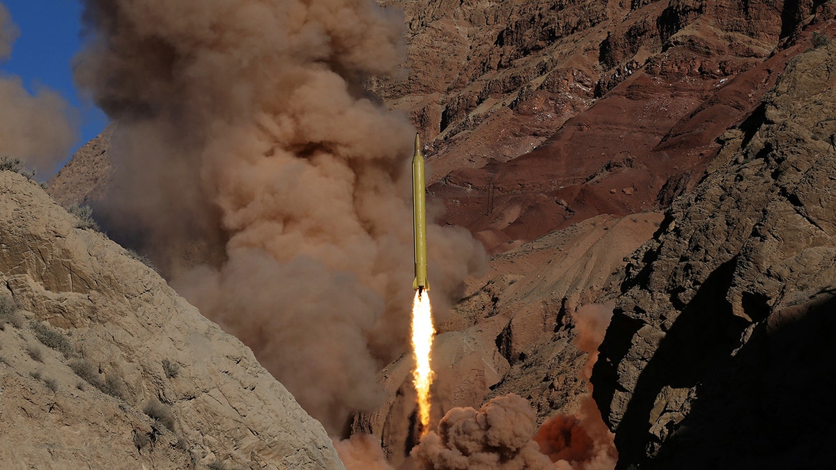 In this file photo obtained from the Iranian Fars News Agency, a Qadr H long-range ballistic surface-to-surface missile is fired by Iran's powerful Revolutionary Guard, during a maneuver, in an undisclosed location in Iran, on March 9, 2016.