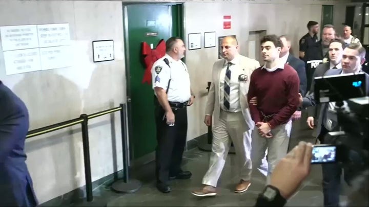 Mangione shakes head while being escorted from NY courtroom