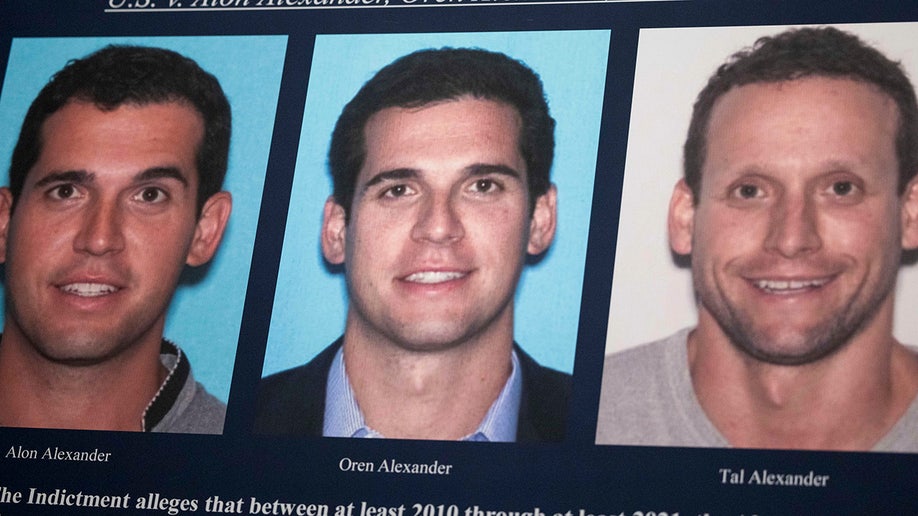 A display showing images of Alon, Oren, and Tal Alexander prior to a news conference in New York