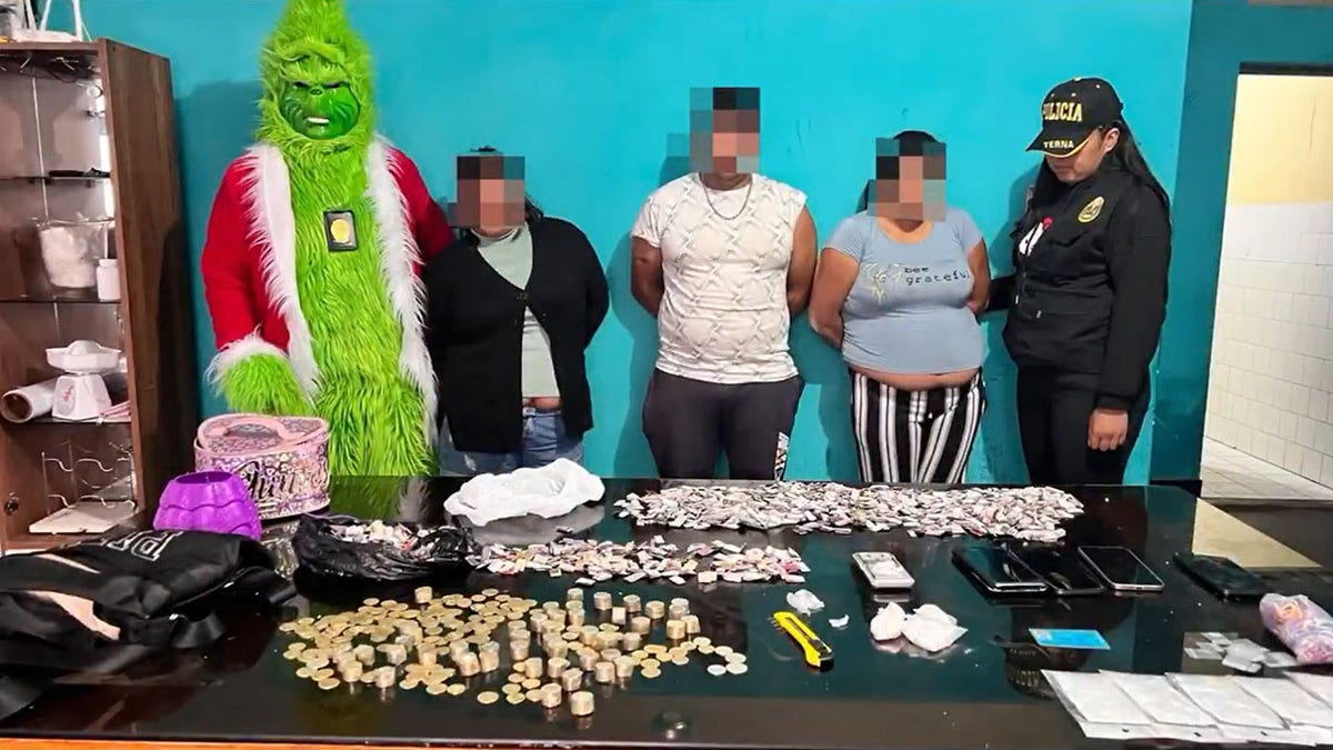 The Grinch posing with suspected drug traffickers.