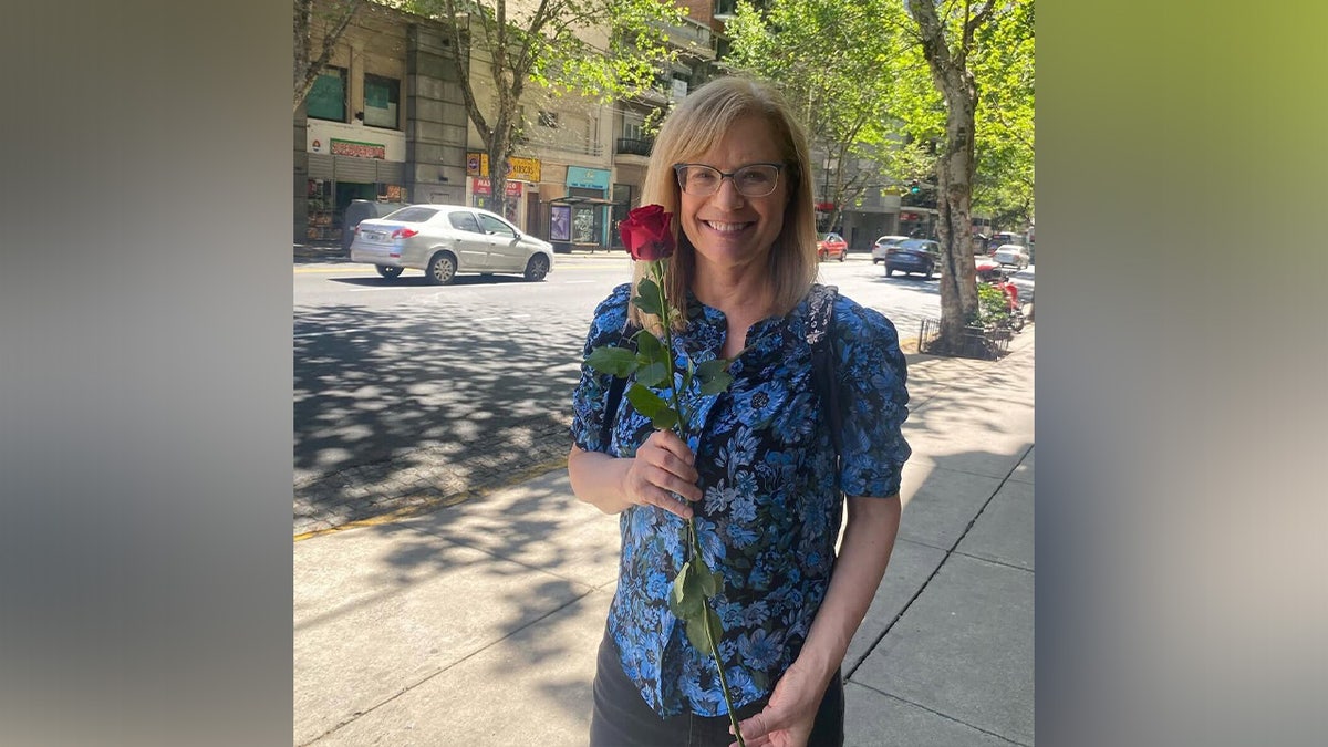 Carol Sbarge holding a flower