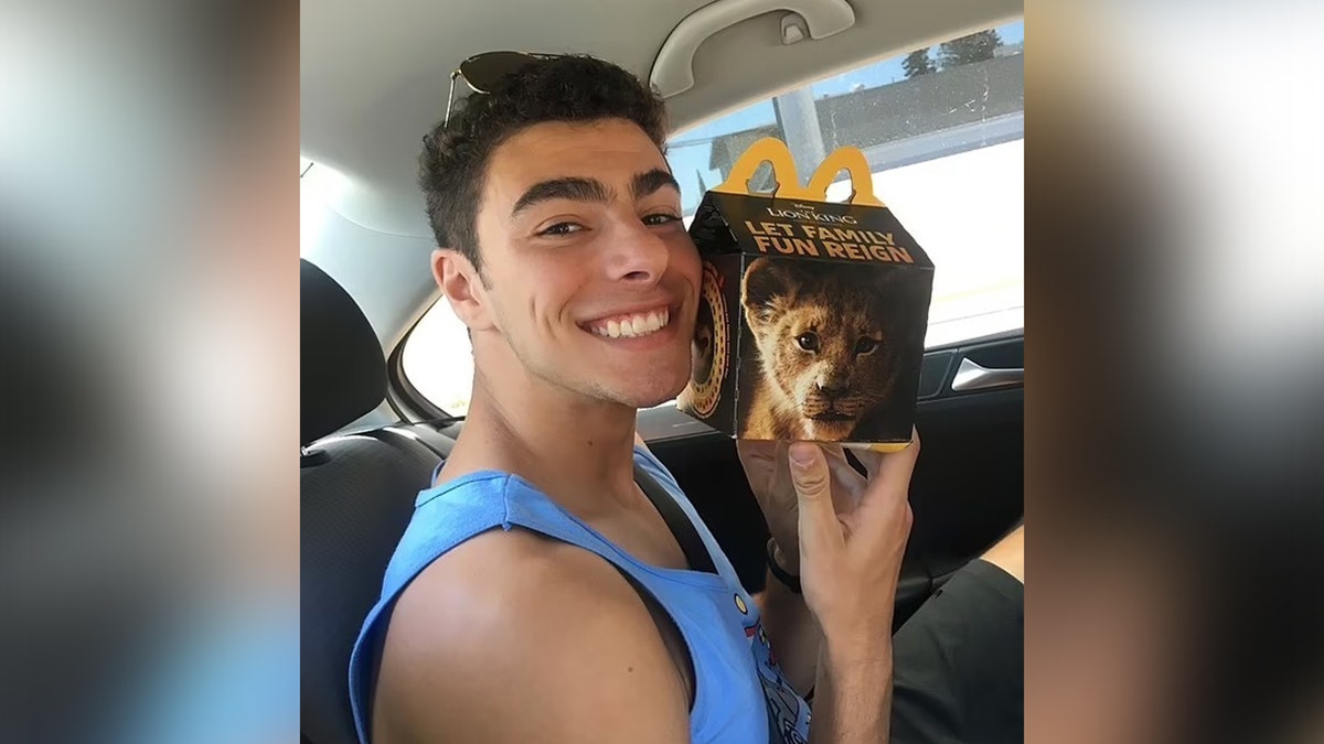 Luigi Mangione poses with a McDonald's meal